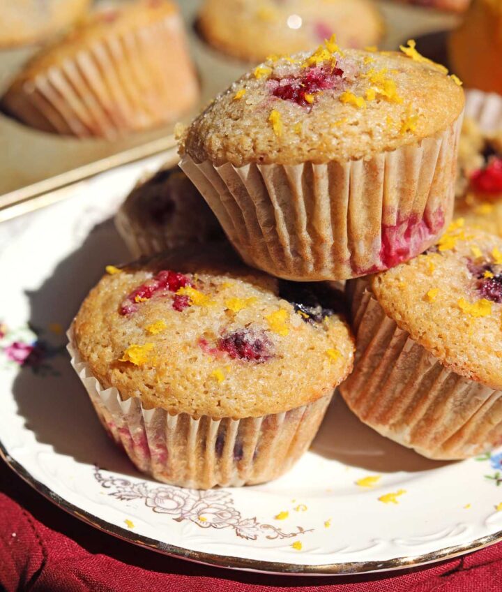 healthy olive oil Greek yogurt berry muffins stacked on a plate