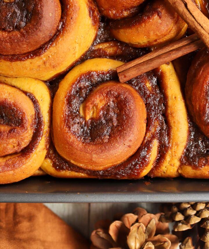 best pumpkin cinnamon rolls in baking pan after baking before adding icing
