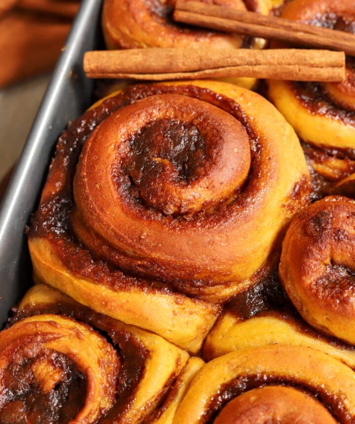 best pumpkin cinnamon rolls in baking pan after baking before adding icing