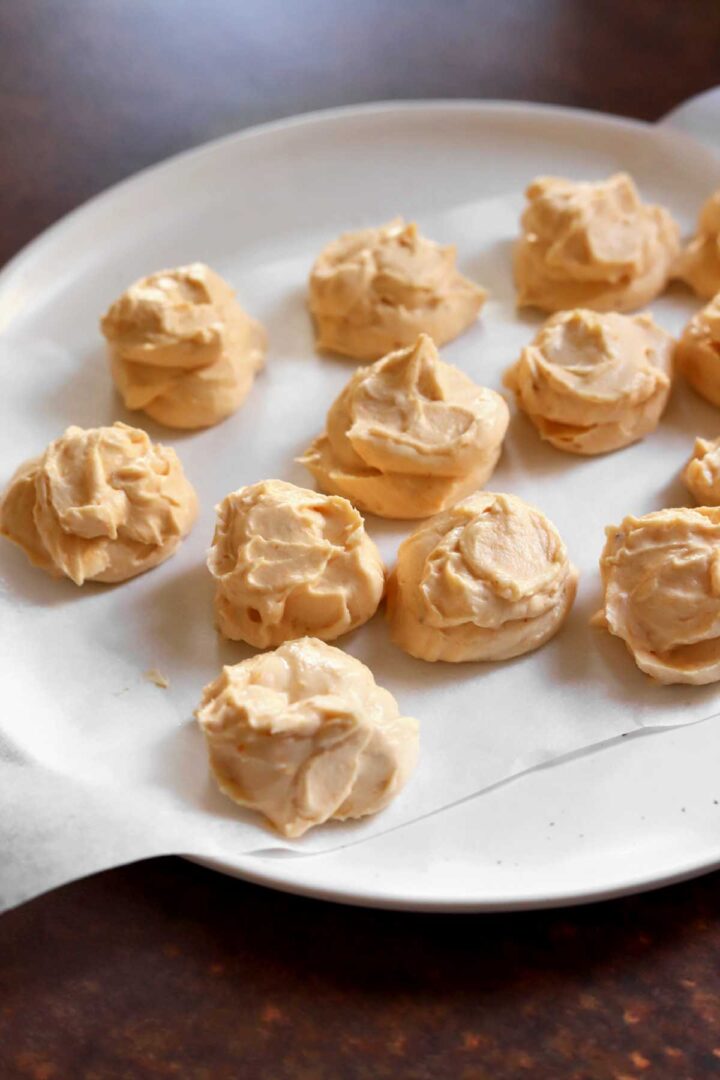 portions of pumpkin cheesecake filling on a plate for freezing before stuffing cookie dough