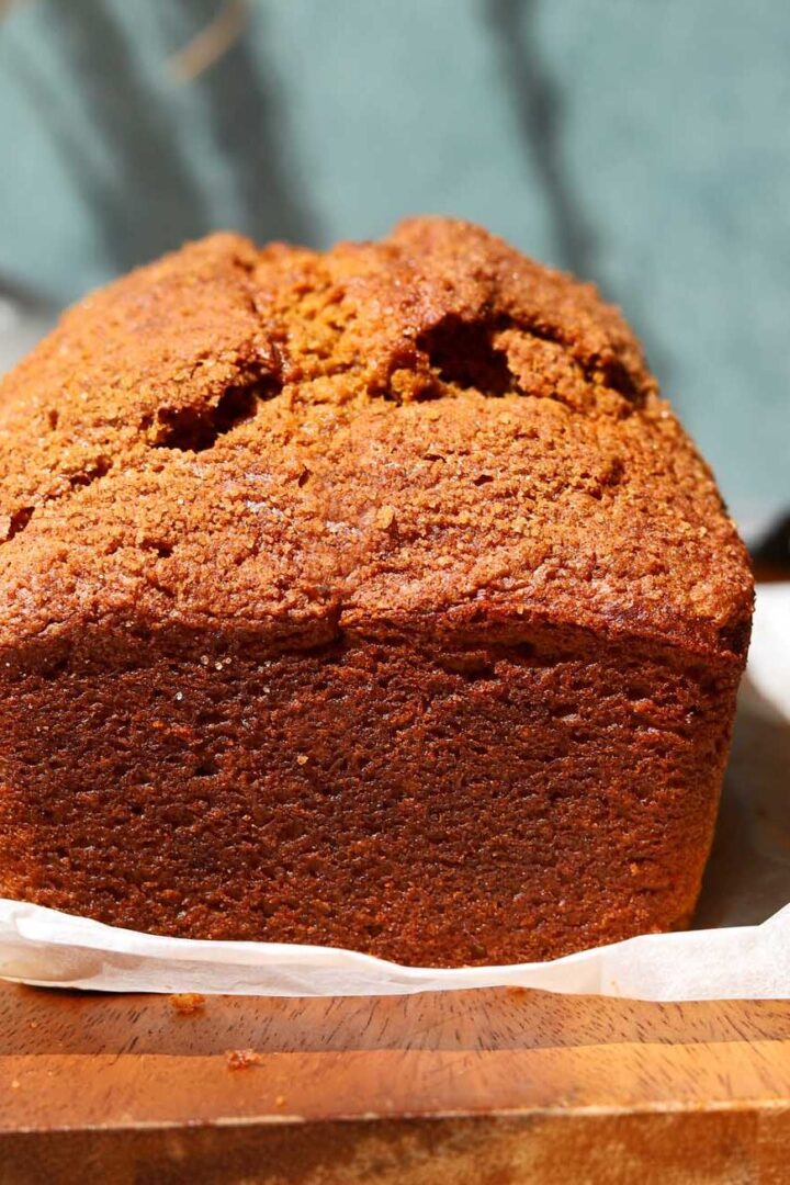 the best pumpkin bread loaf on cutting board before slicing