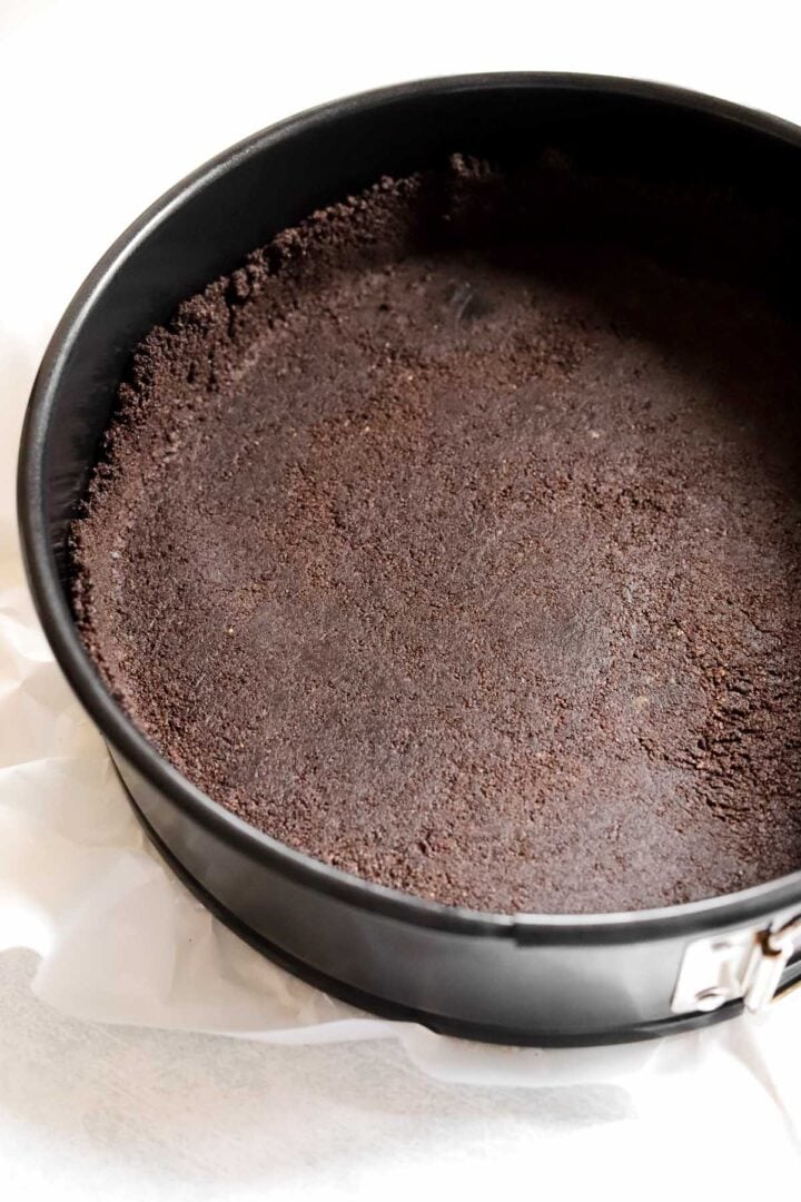 Oreo cookie crust for cookies and cream cheesecake before baking