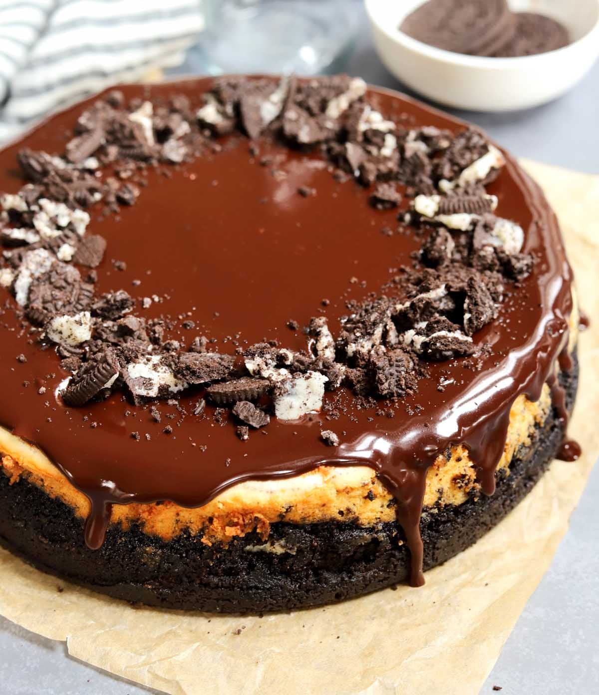 Oreo cookies & cream cheesecake before slicing on parchment paper