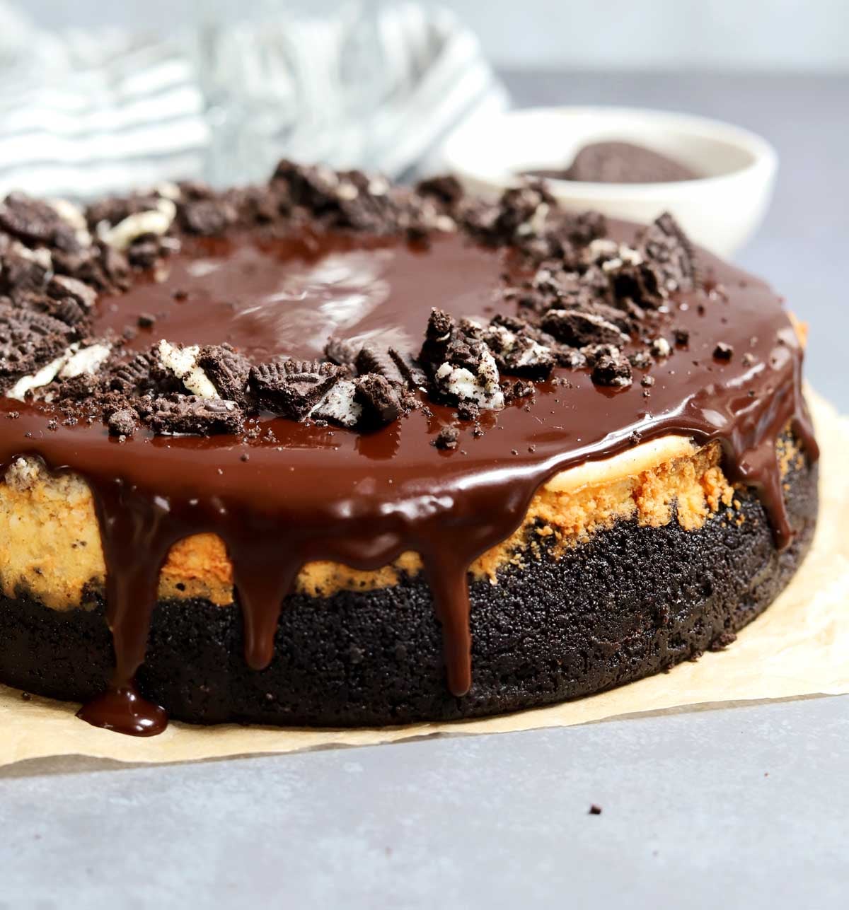 Oreo cookies & cream cheesecake before slicing on parchment paper