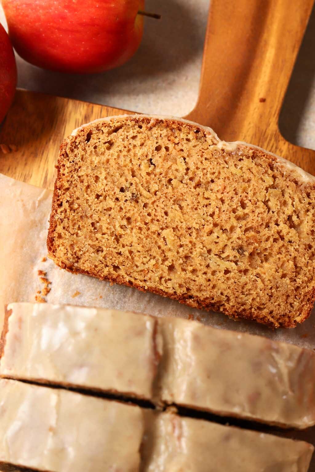 top view of a slice of brown butter apple bread on cutting board