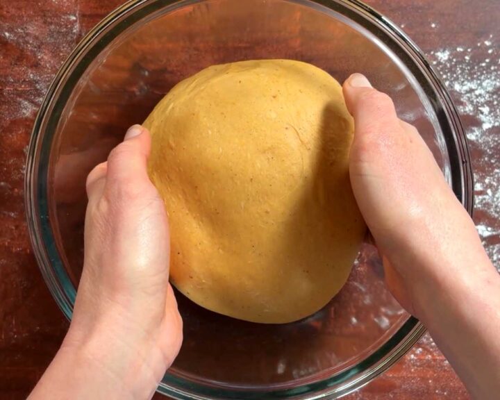 Place the dough into a bowl to rise in a warm place. Lightly oil the surface and cover it.