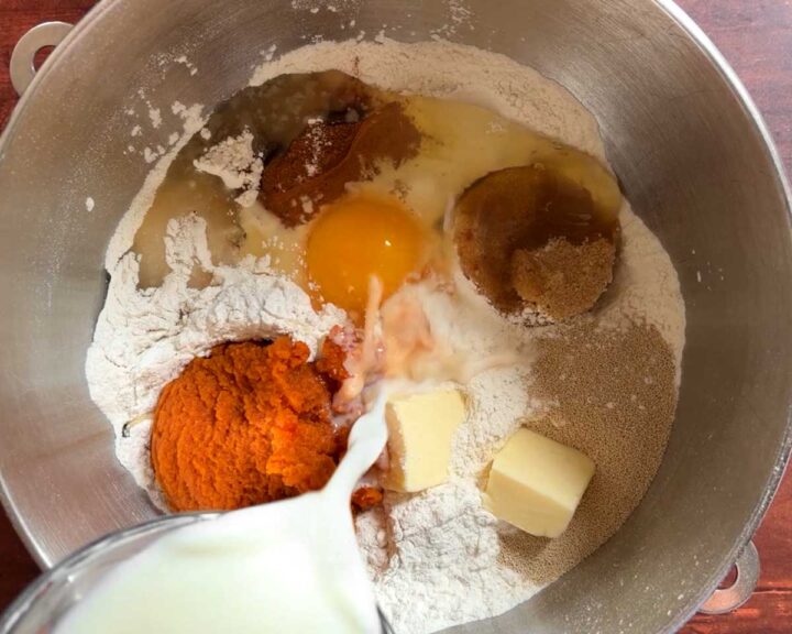 Combine all pumpkin cinnamon roll dough ingredients in a stand mixer bowl.