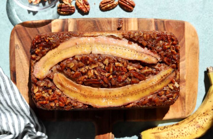 top view of sticky caramelized pecan banana bread on cutting board