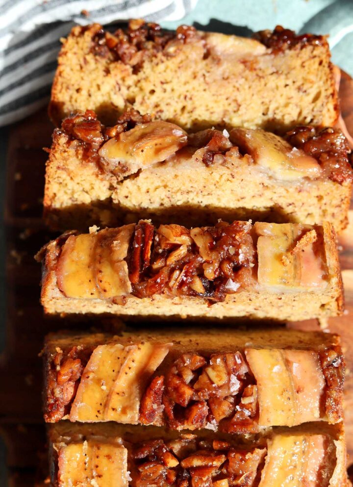 top view of sticky caramelized pecan banana bread sliced on cutting board