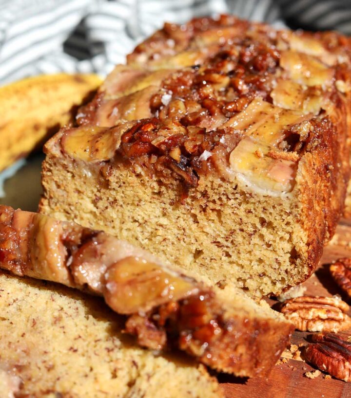 sticky caramelized pecan banana bread sliced on cutting board