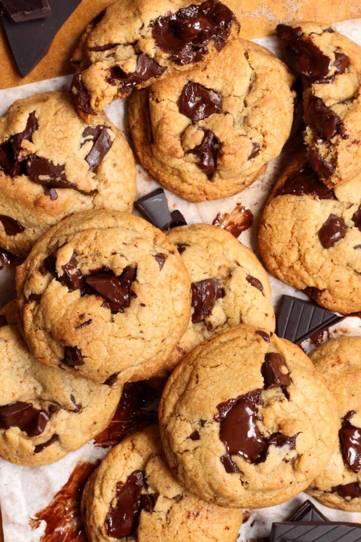 thick brown butter chocolate chunk cookies piled up on baking tray
