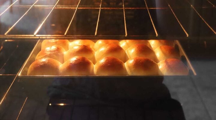 soft homemade dinner rolls baking in the oven