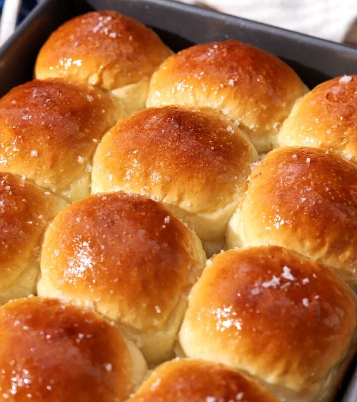 angle view of soft homemade dinner rolls in baking pan