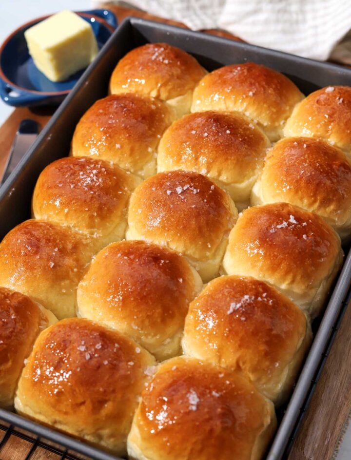 angle view of soft homemade dinner rolls in baking pan