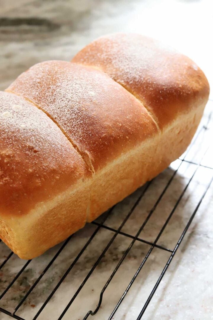 homemade sandwich bread after baking, cooling on wire rack