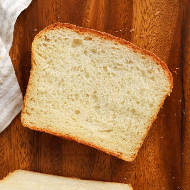 top view of a slice of homemade sandwich bread on a cutting board