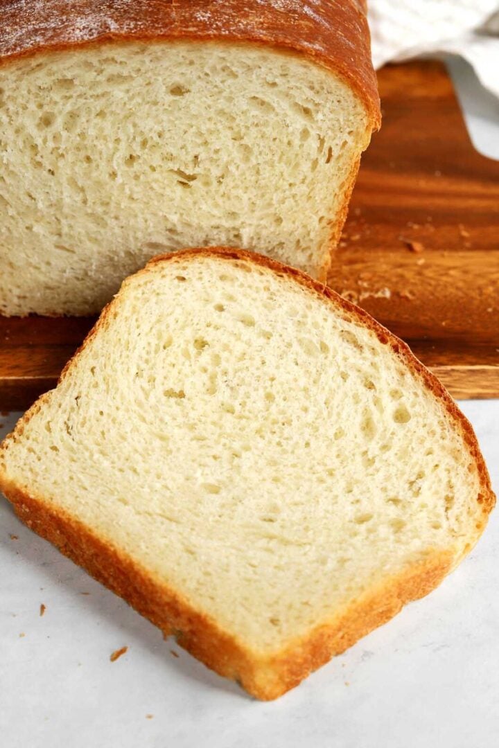 a slice of homemade sandwich bread on a cutting board