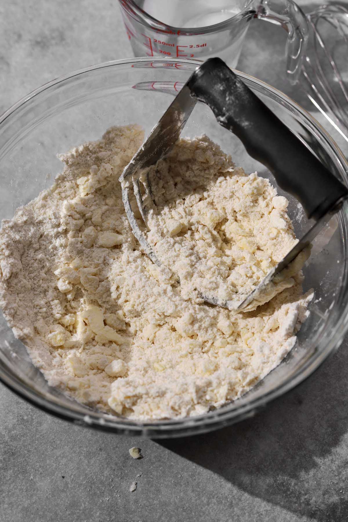 cutting in remaining butter in larger pieces until it looks like rubble