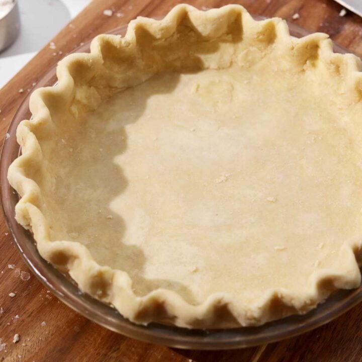 single pie dough in base of pie dish with fluted edges