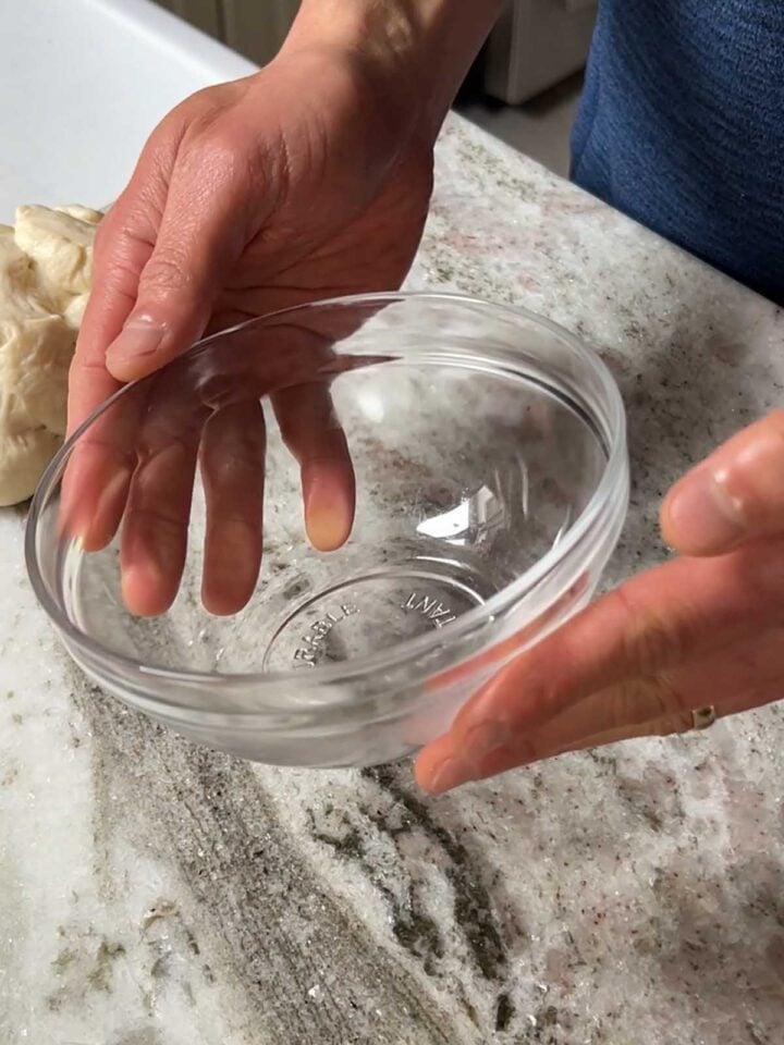 Use a glass bowl about an inch in diameter larger than the dough ball to help create tension.