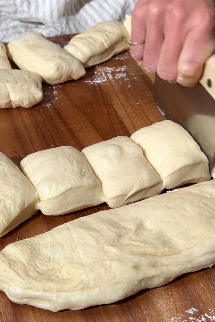 Pat the dough out on a surface and divide it into 15 portions.