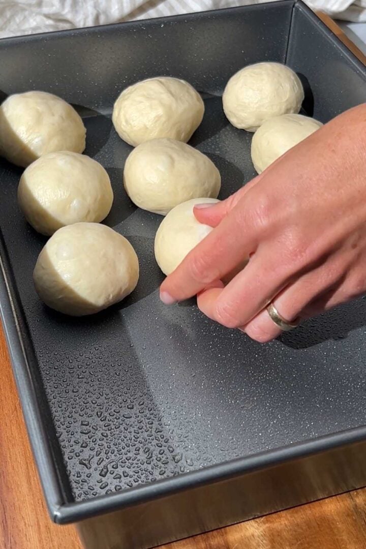Place the shaped dough balls into the pan with even spacing between them.