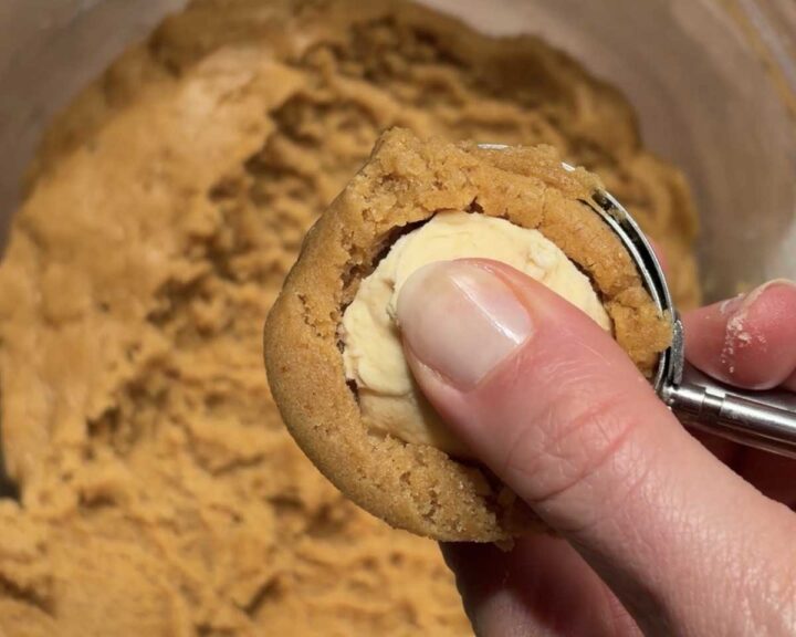 Press a ball of pumpkin cheesecake into the center of each dough ball.